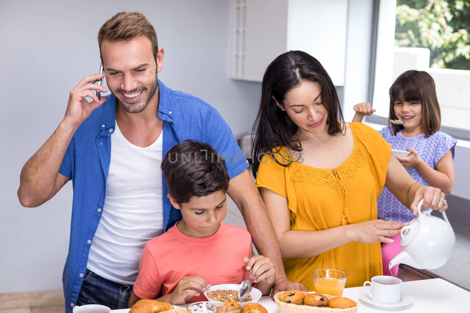 Happy family in kitchen by Wavebreakmedia