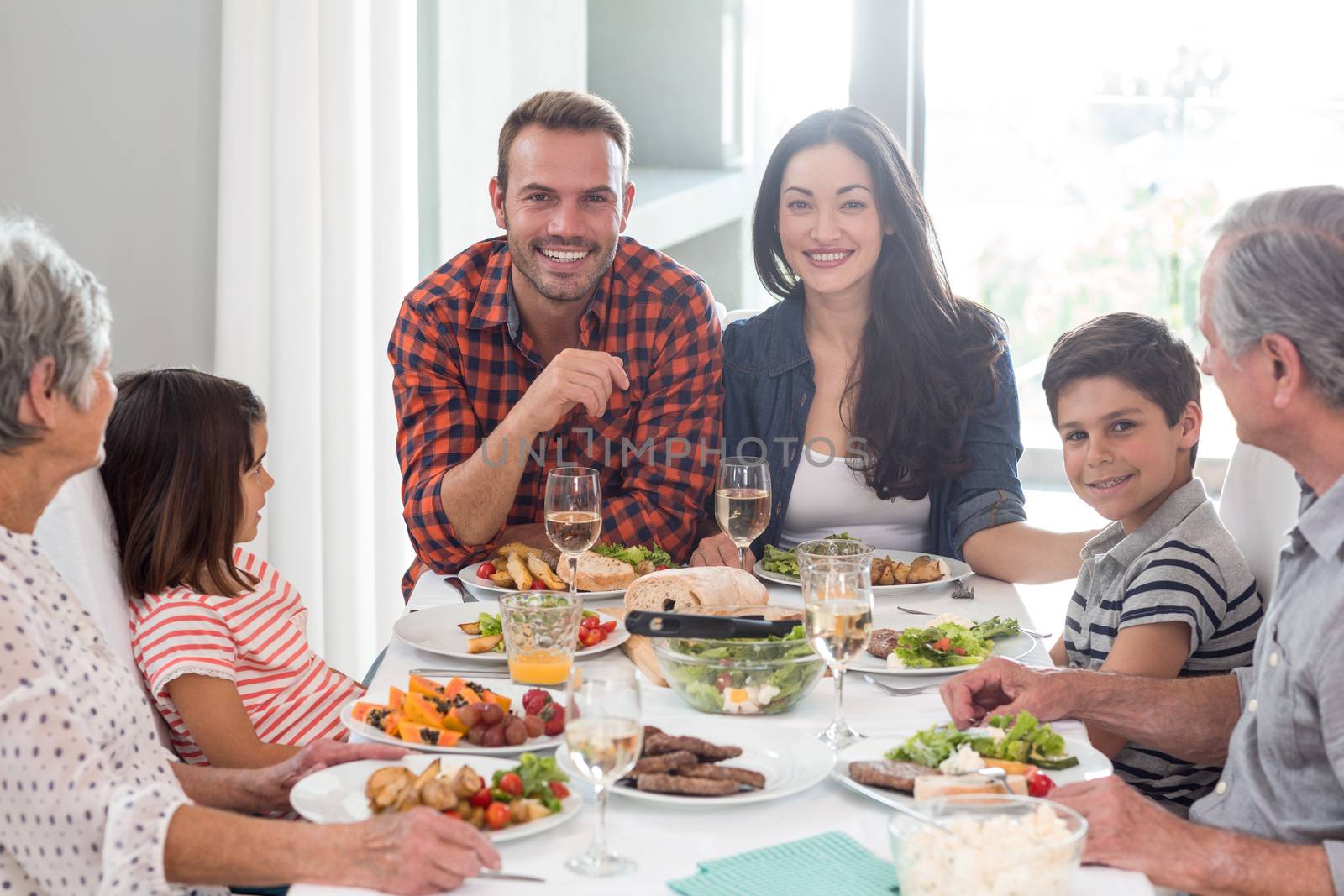 Family sitting at dining table having meal