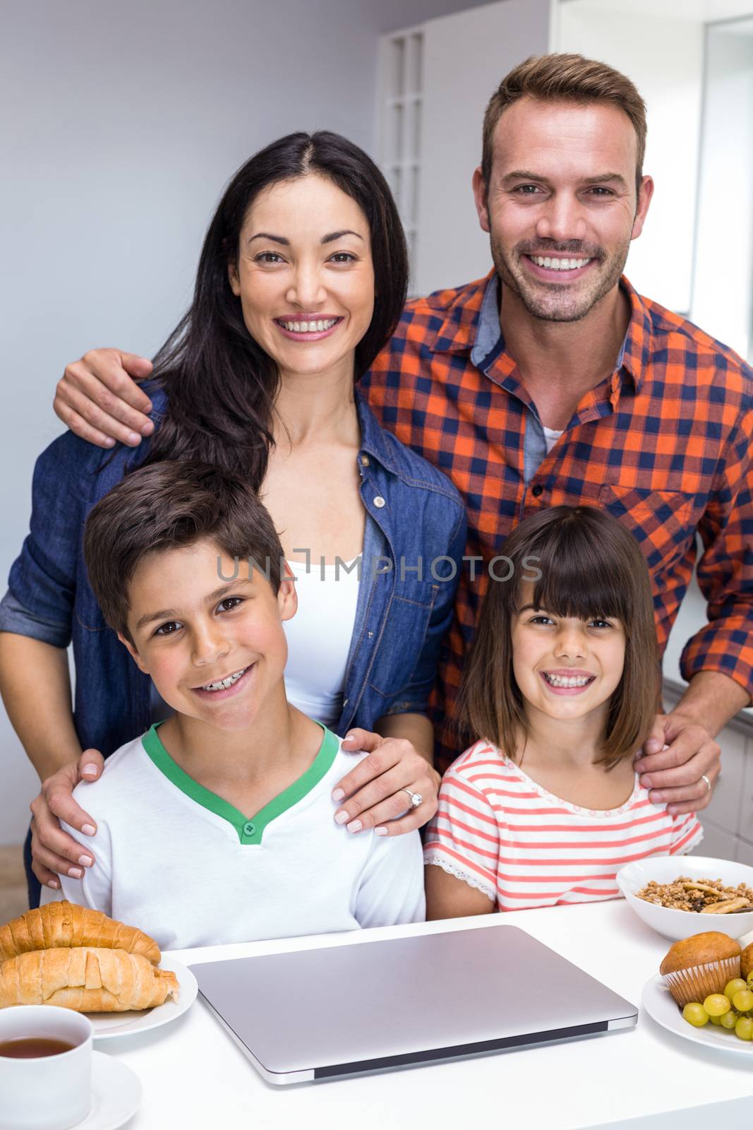 Happy family in the kitchen having breakfast