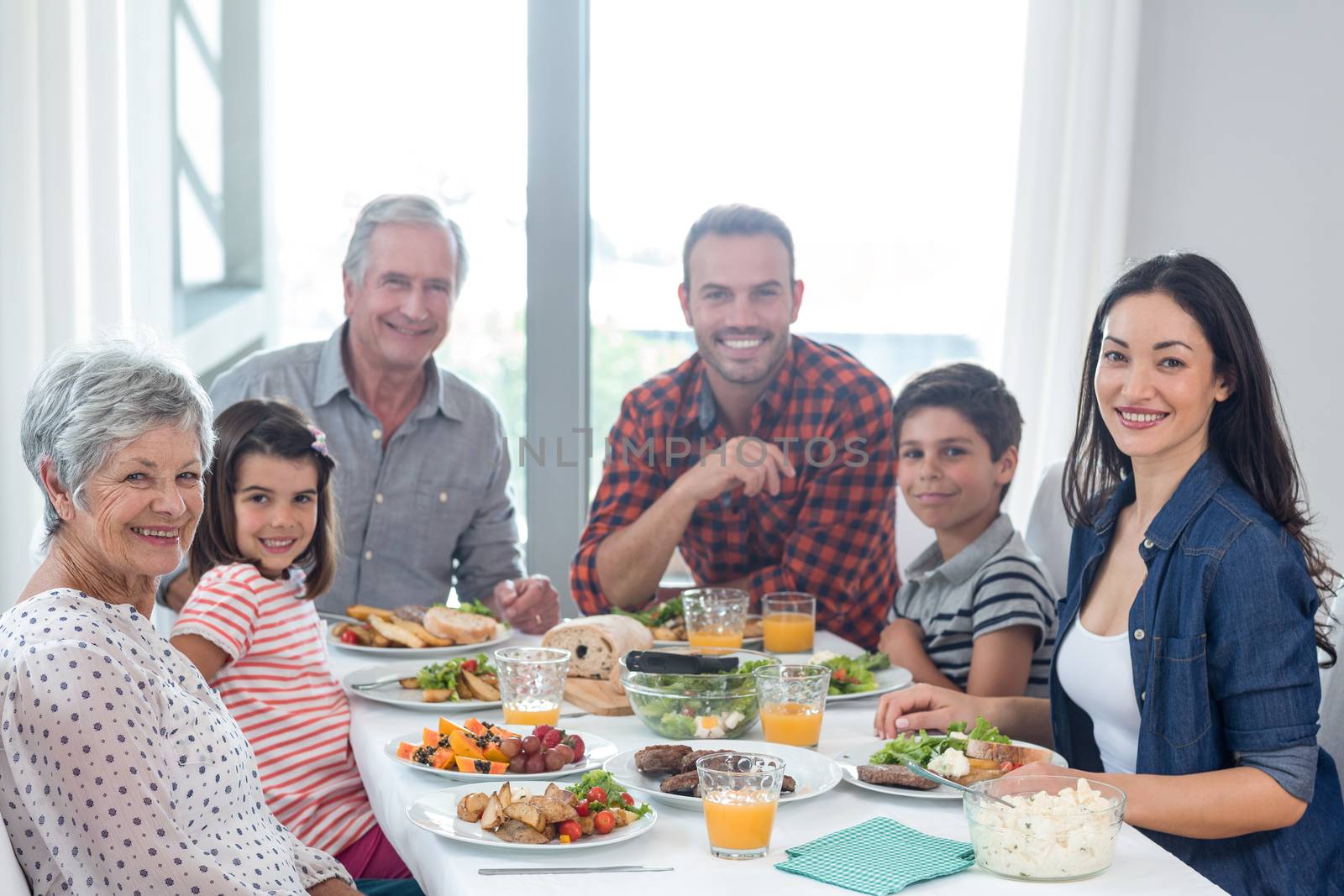 Portrait of happy family having breakfast in the morning