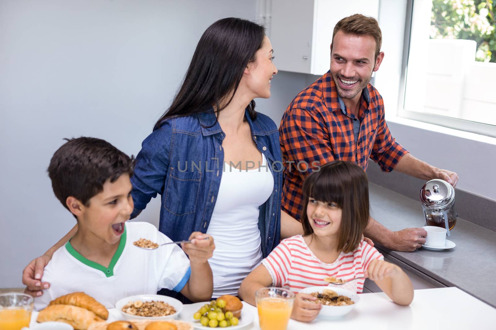 Happy family in kitchen by Wavebreakmedia