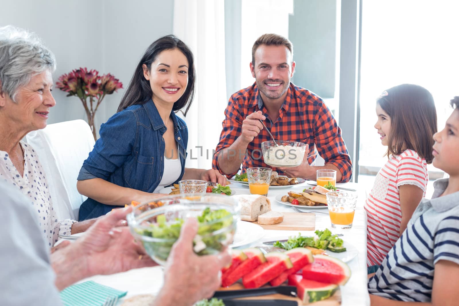 Happy family having breakfast by Wavebreakmedia