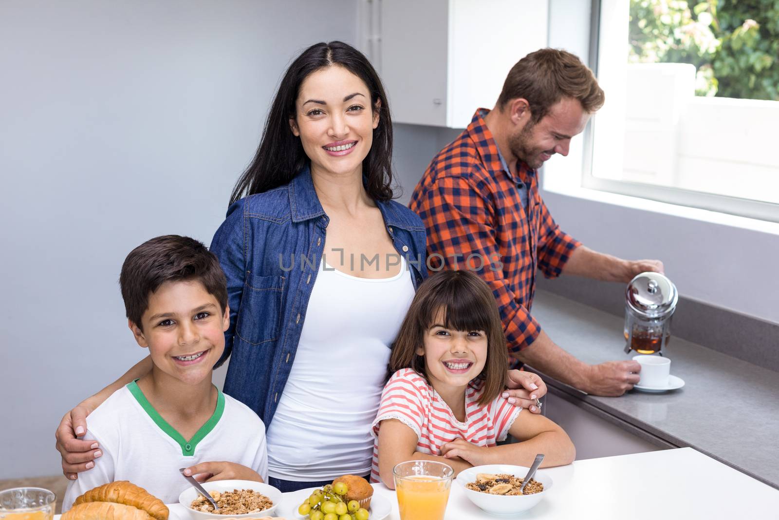 Happy family in the kitchen having breakfast