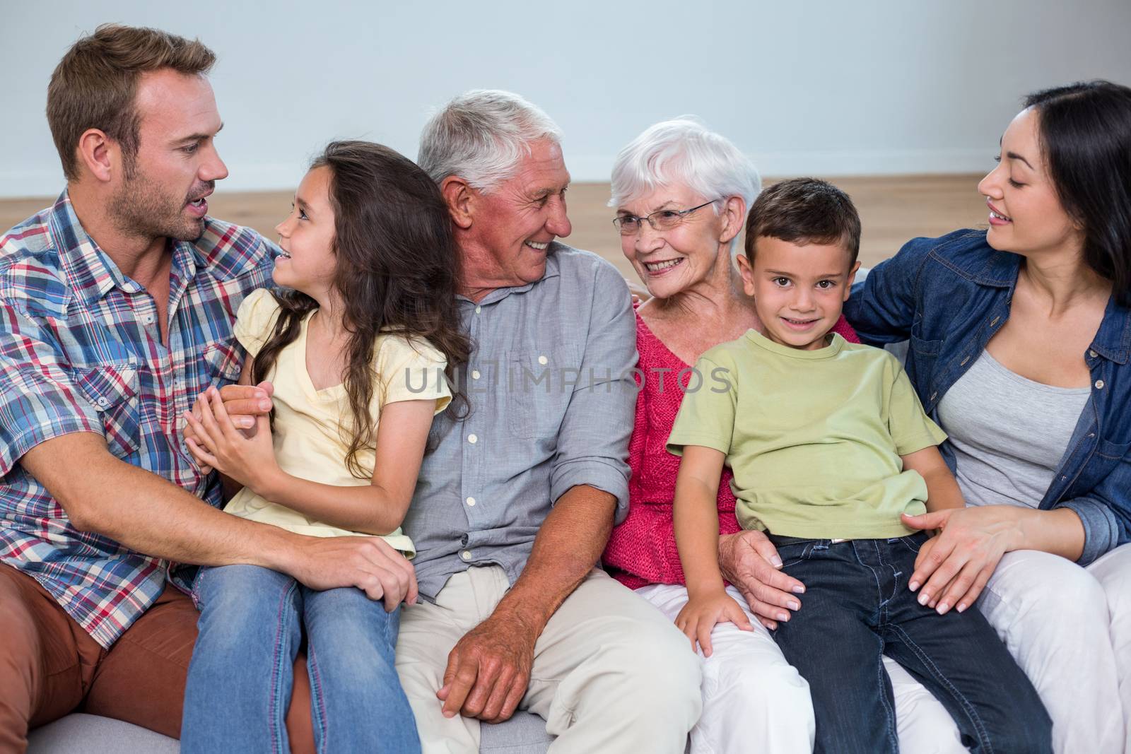 Family sitting on sofa and interacting with each other in living room