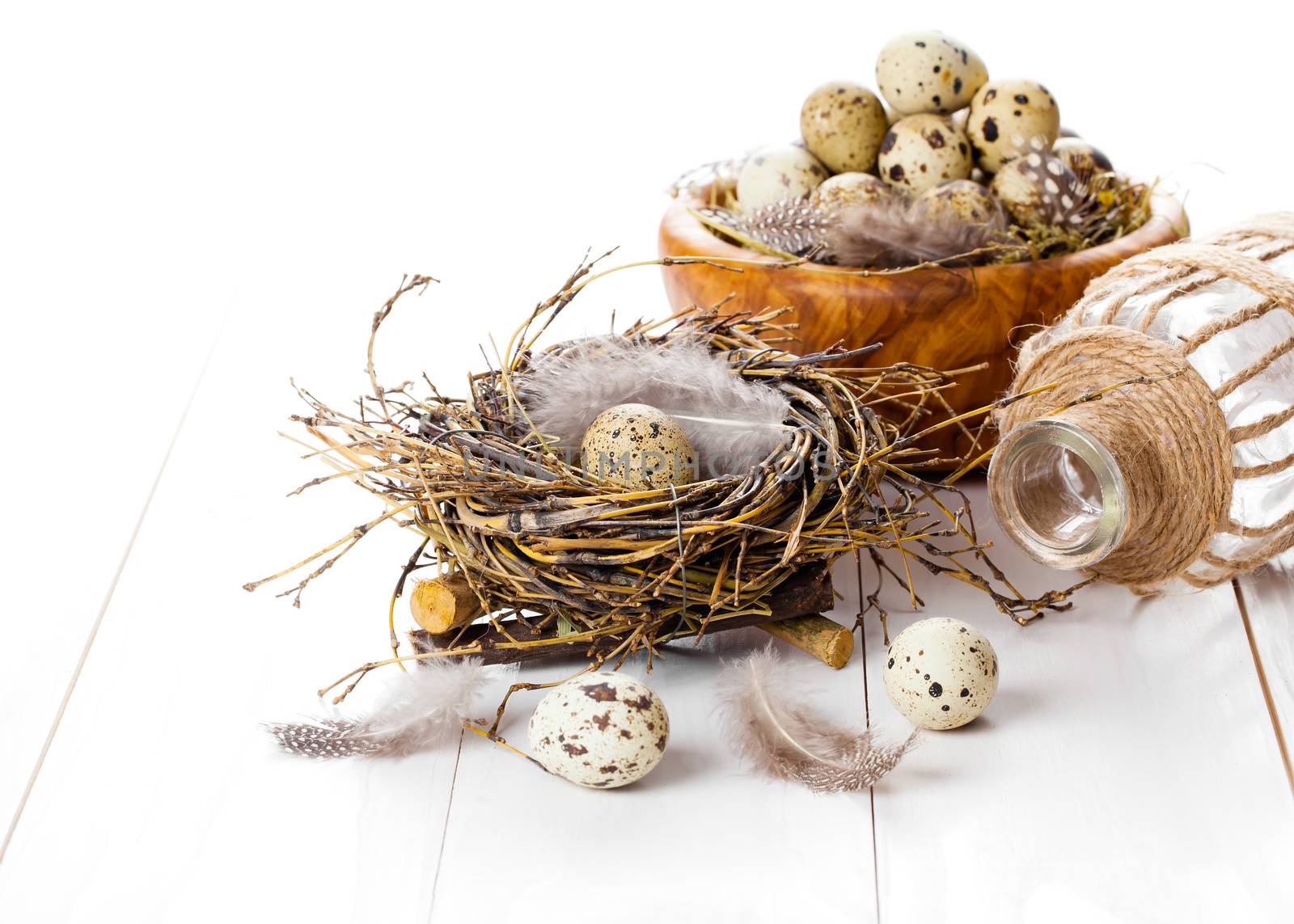 table decoration on white wooden background with quail eggs by motorolka