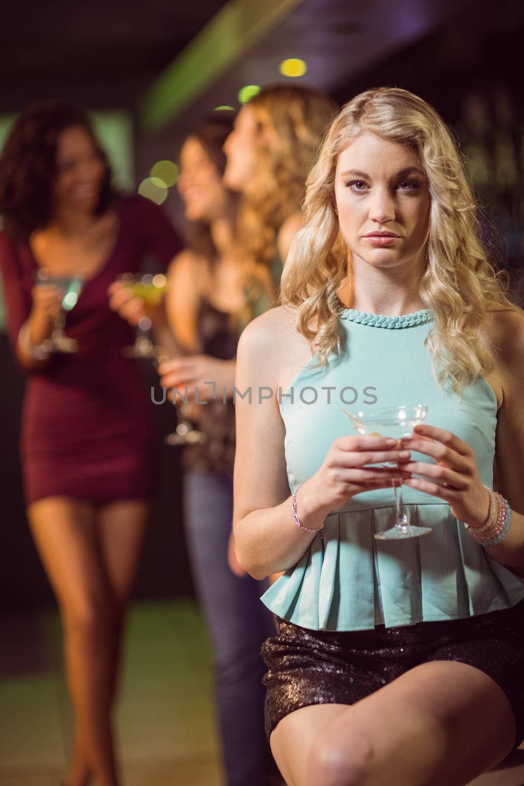 Blonde woman drinking cocktail by Wavebreakmedia