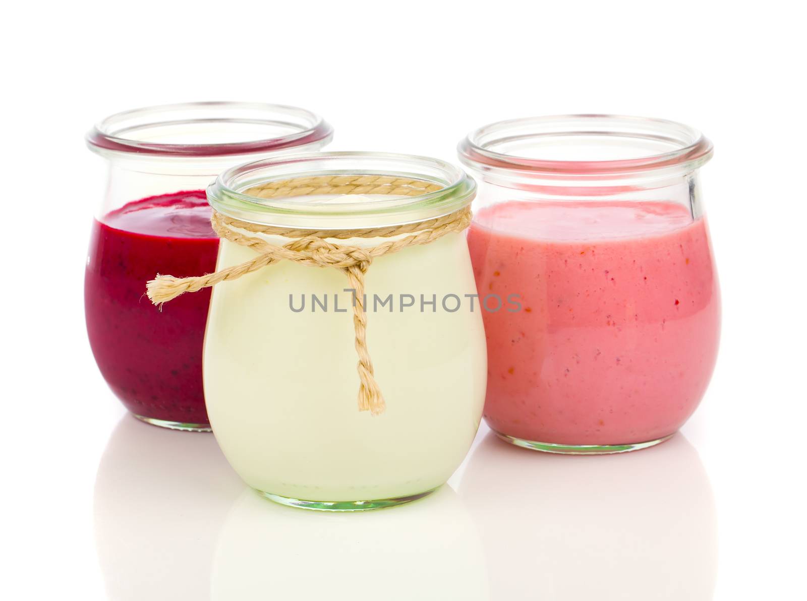 Delicious, nutritious and healthy yogurt in a glass jars on a wh by motorolka