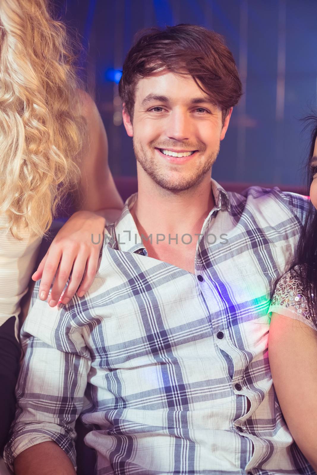 Happy man smiling at camera in a club