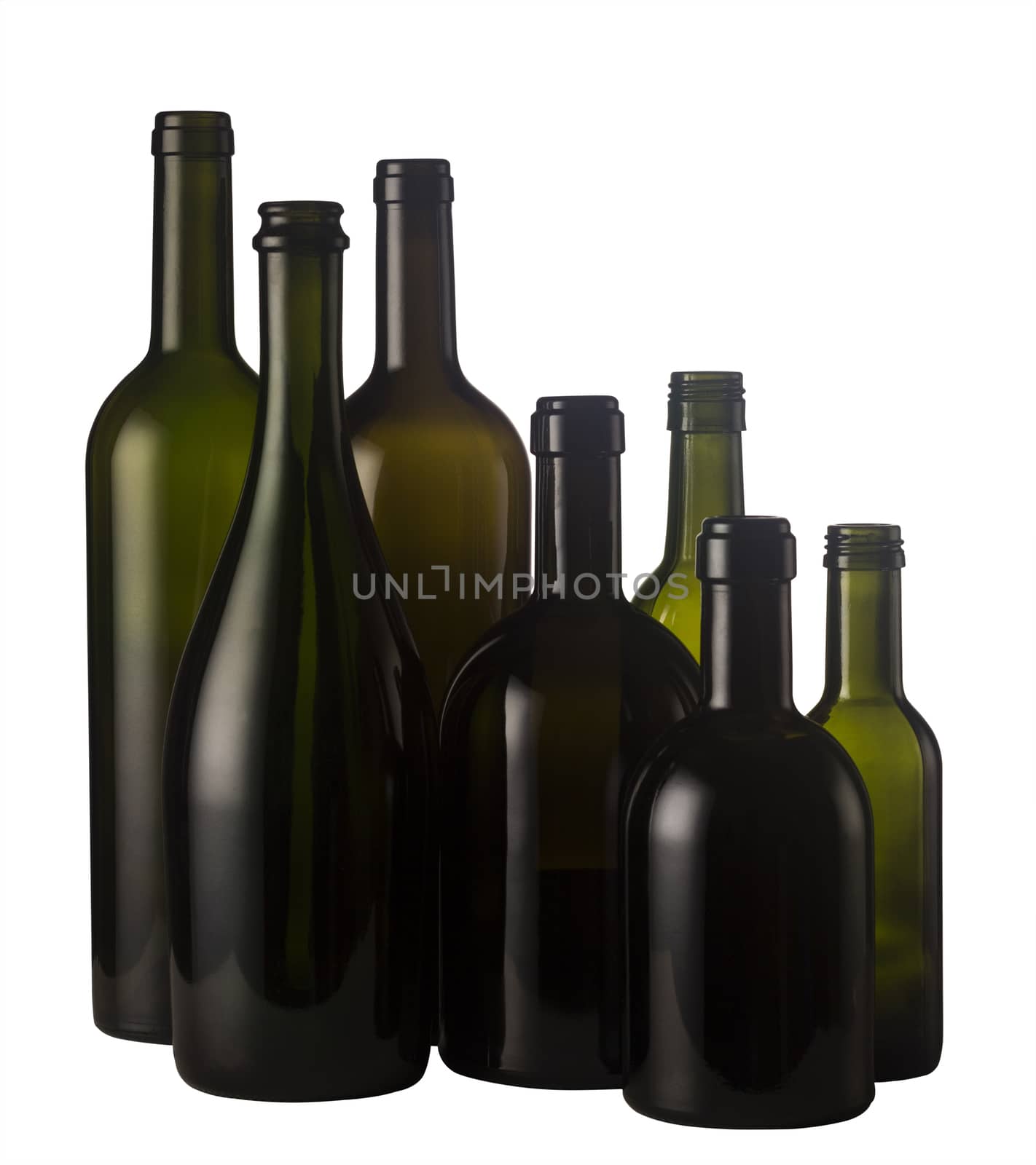 Horizontal front view of a group of empty wine bottles of different sizes, shapes and colorisolated on white background.
