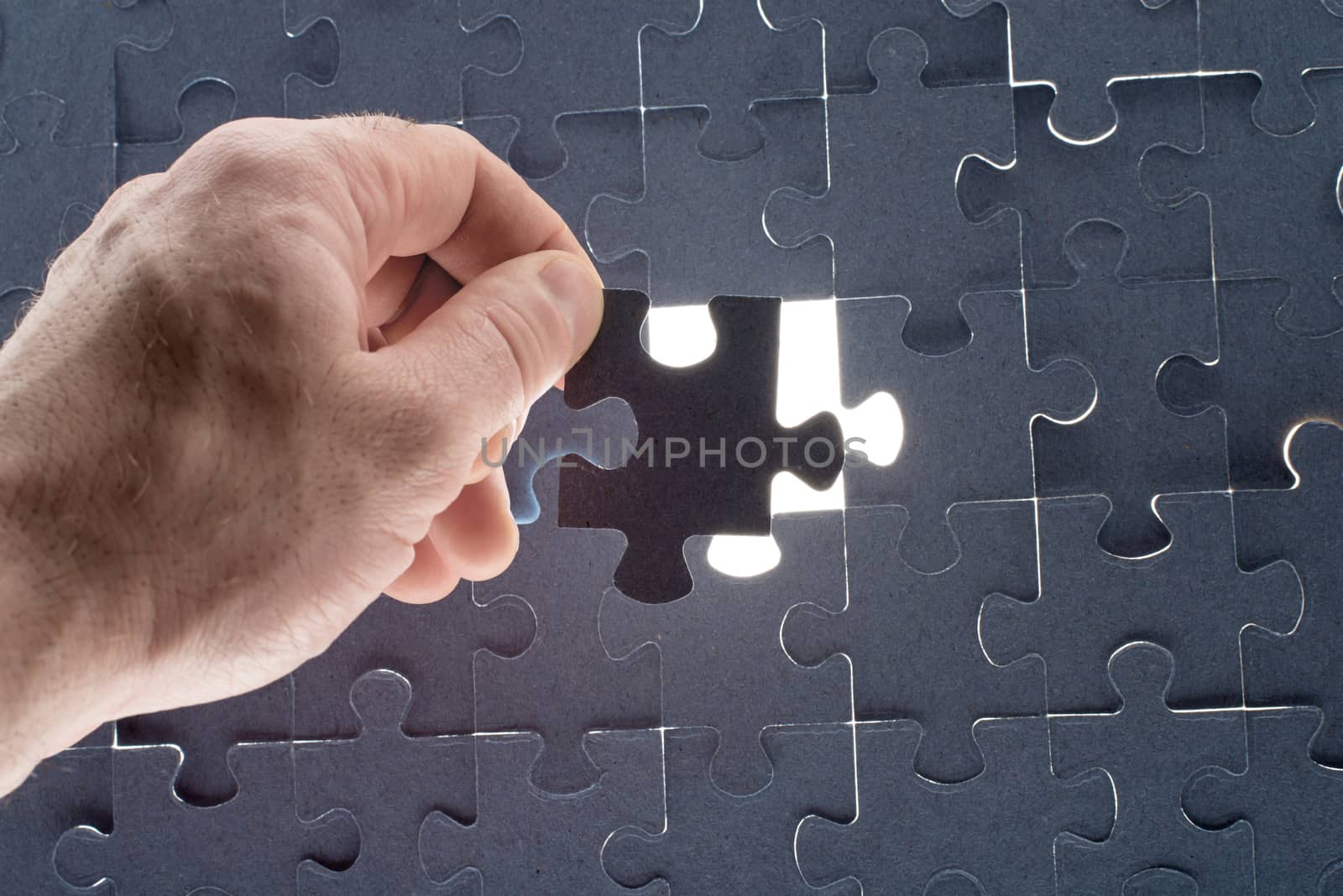 Missing jigsaw puzzle piece with light glow by cherezoff