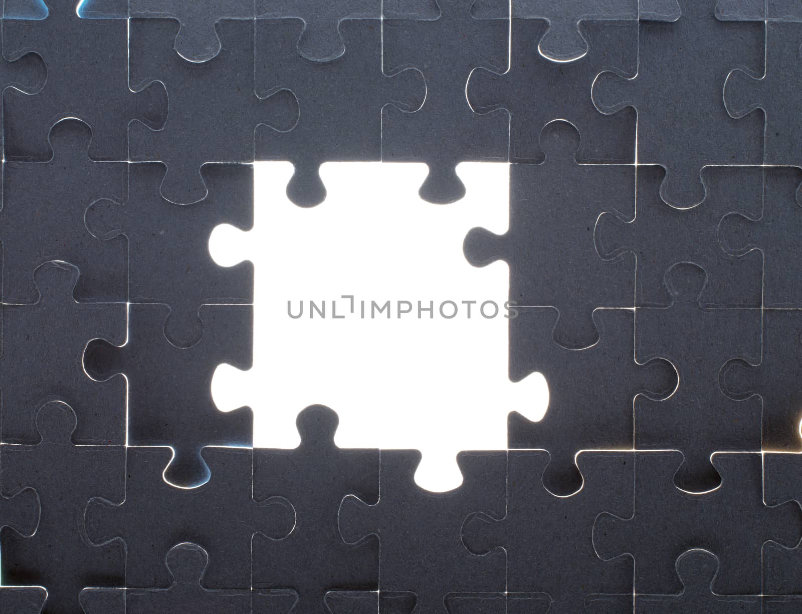 Grey puzzle background with big empty white space, close up view