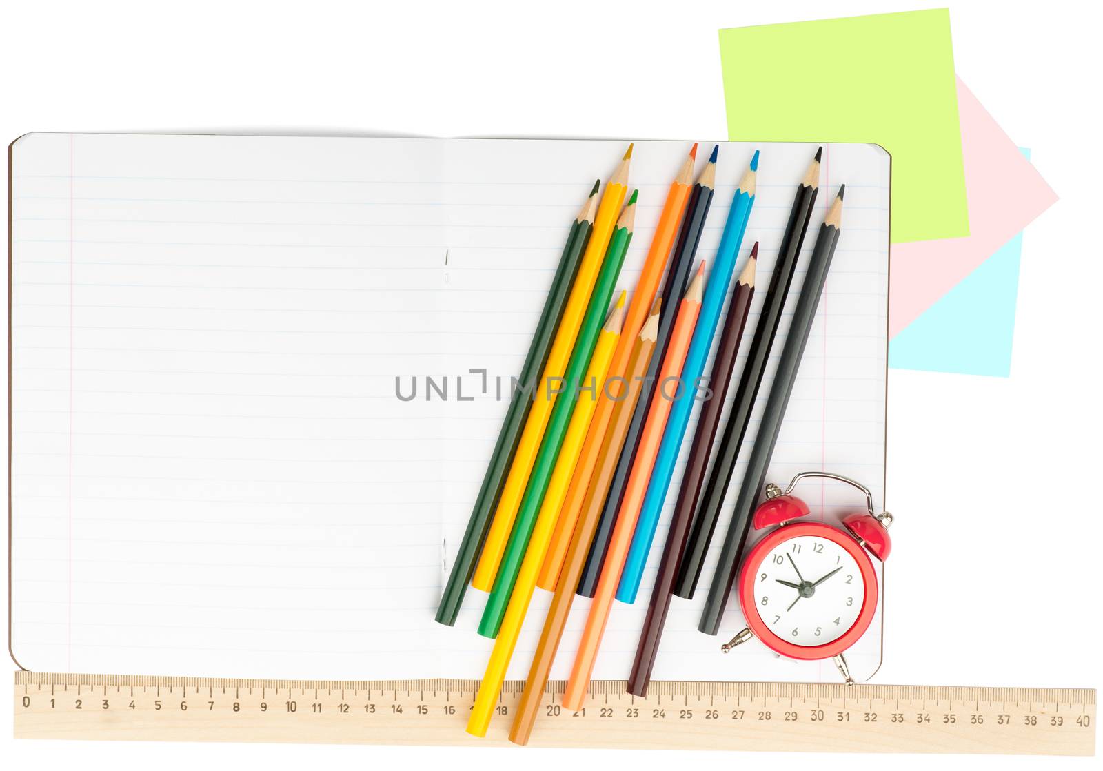 Open notebook with crayons, stickers and alarm clock on isolated white background, closeup