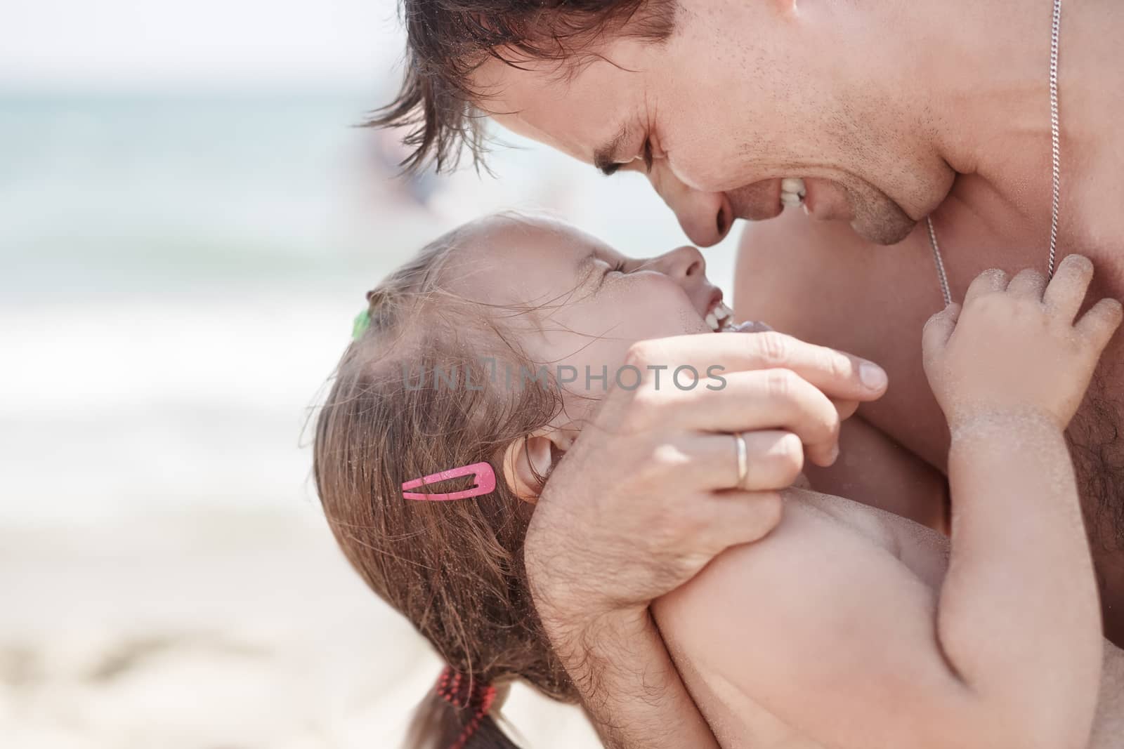 Dad and daughter embracing each other laugh. Closeup photo. Shallow depth of field.