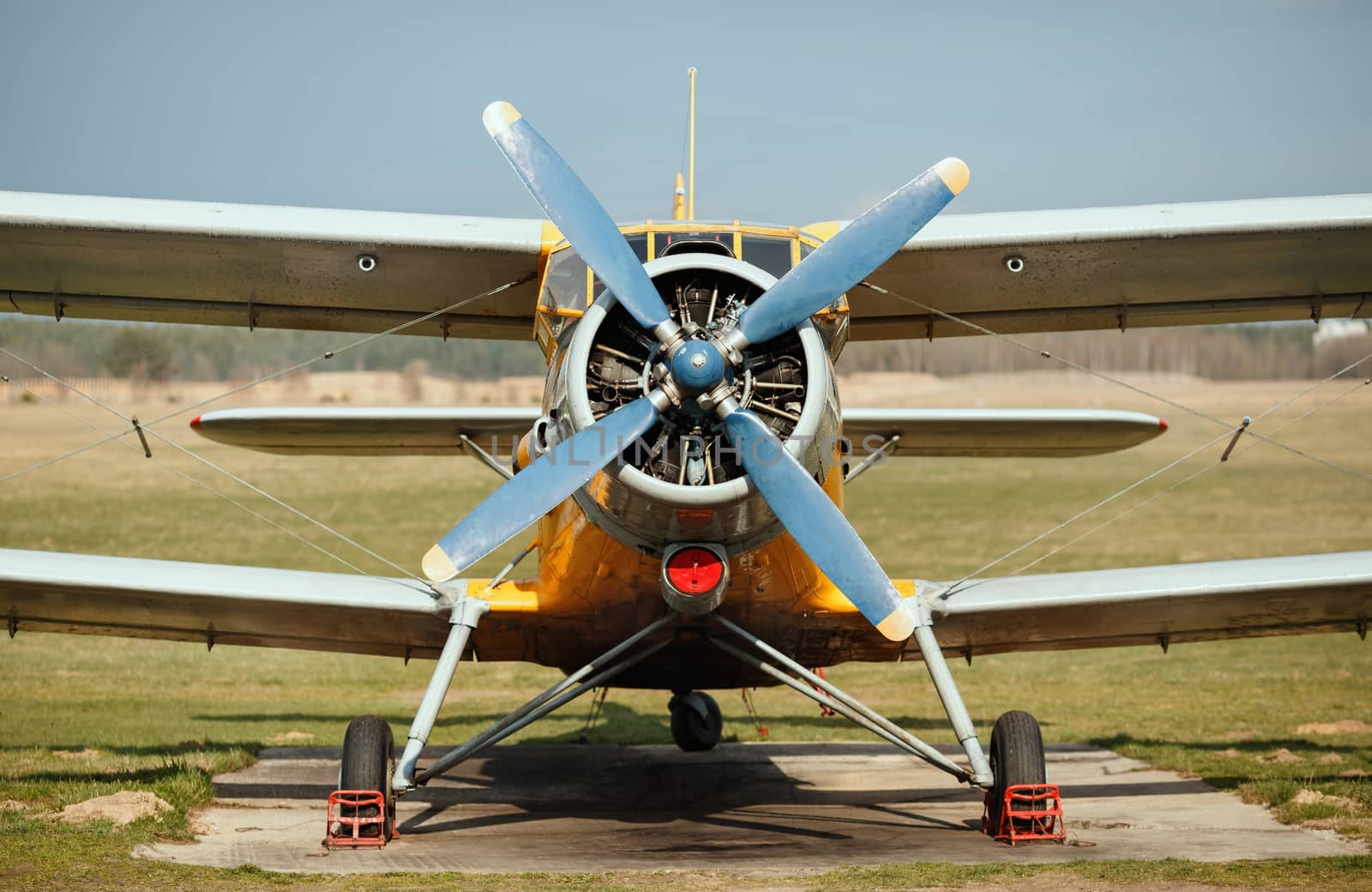 Airplane with blue propeller. Old retro plane close-up. Front view, with the side of the fuselage.