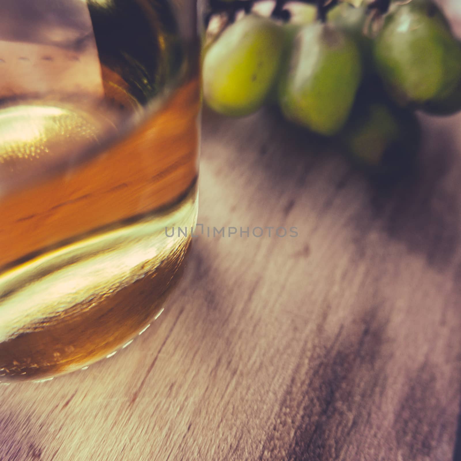 Detail Of A Bottle Of White Wine And Grapes On A Rustic Wooden Table With Copy Space