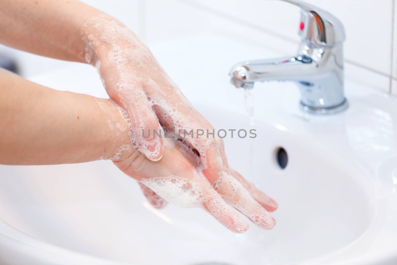 Washing of hands with soap under running water. Hygiene and Cleaning Hands.