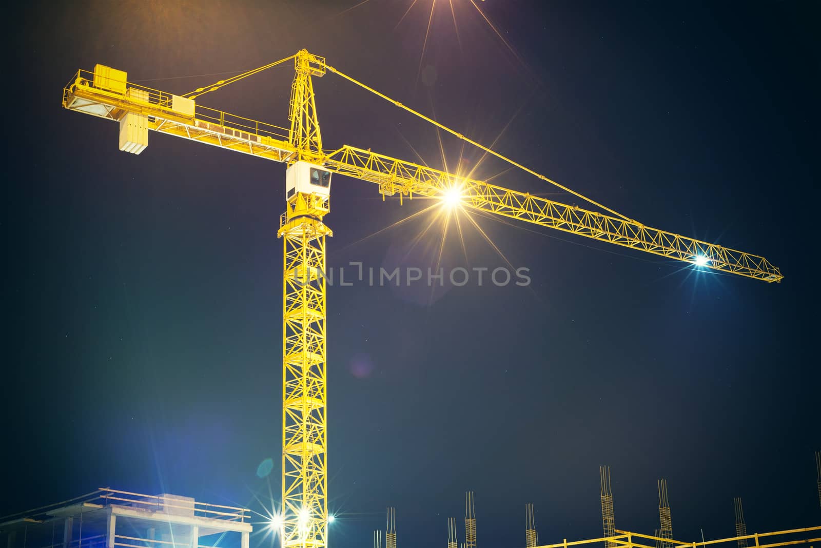 crane and illumination at night, construction site