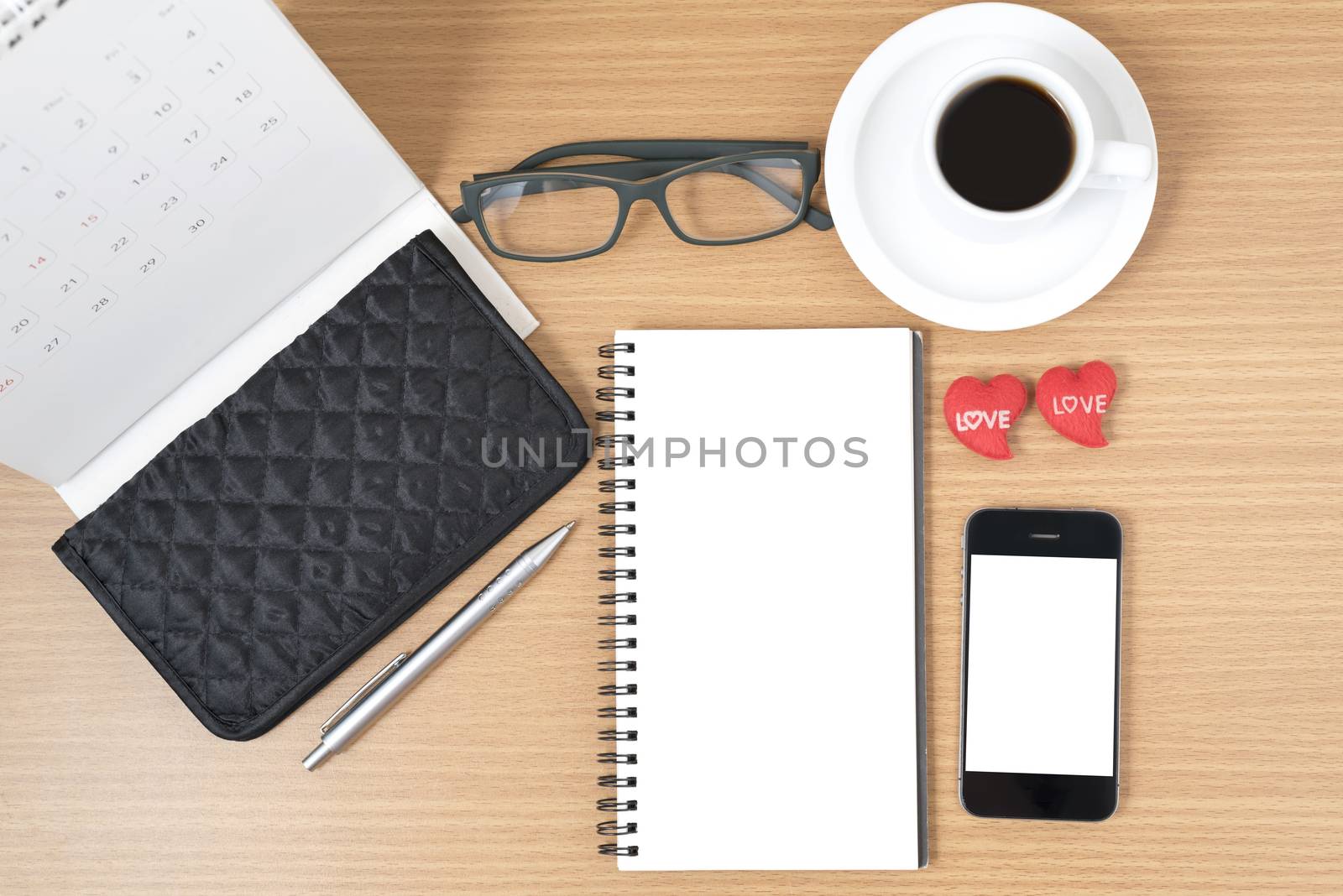 office desk : coffee with phone,wallet,calendar,heart,notepad,eyeglasses,heart on wood background