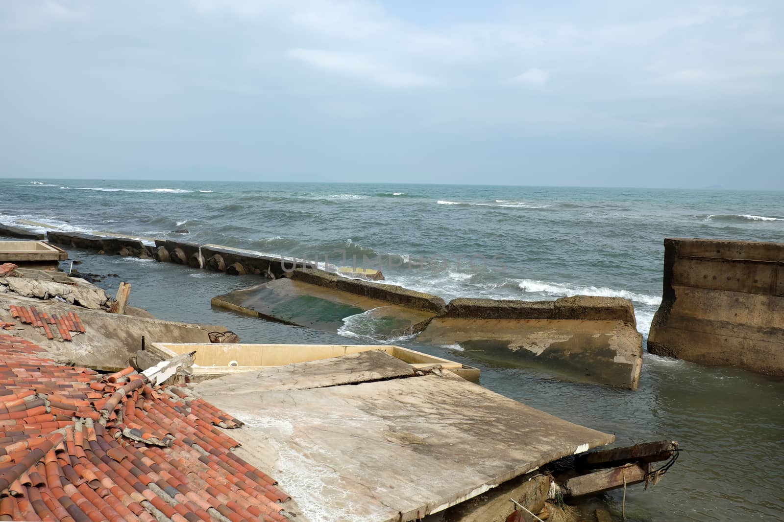 Erosion at seaside resort from climate change situation, wave broken building, very unsafe, danger, environment risk of worldwide when sea level rise by warming, scene at Cua Dai, Hoi An, Vietnam