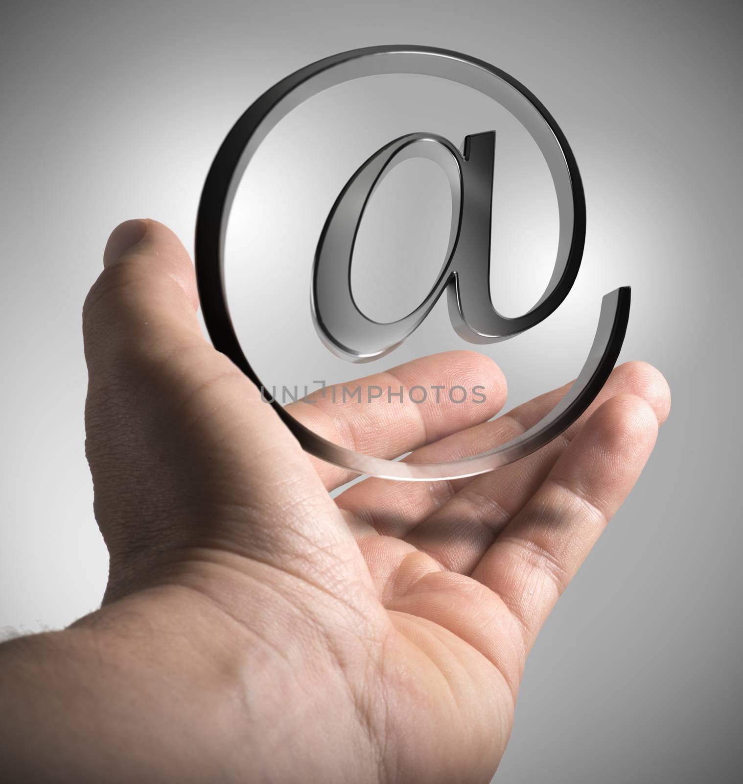 Hand holding email symbol over grey background. Emailing or Marketing concept