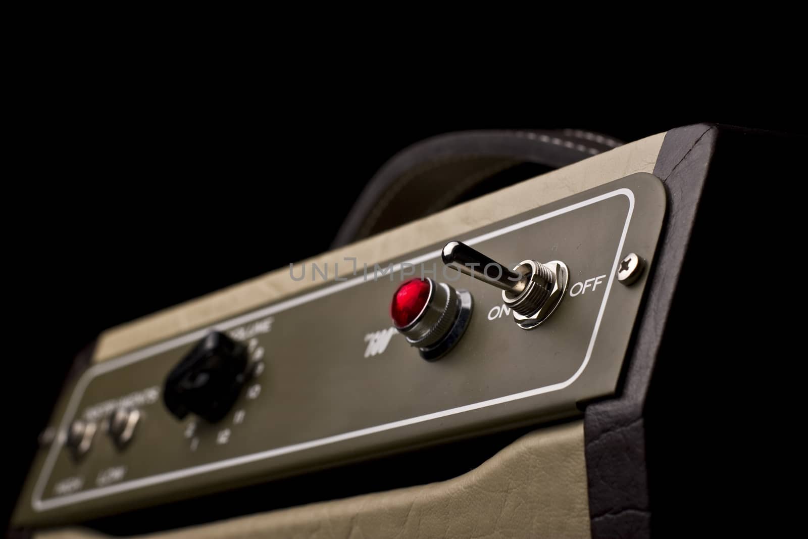 Close up of a small electric guitar amplifier on dark background 