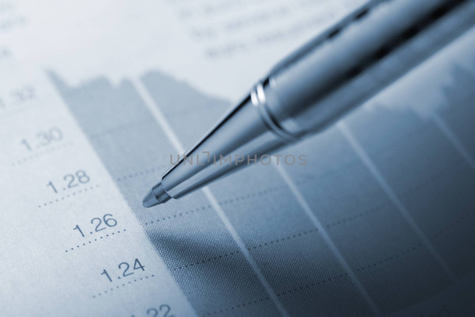 Horizontal top view of a pencil above a graphic printed on paper