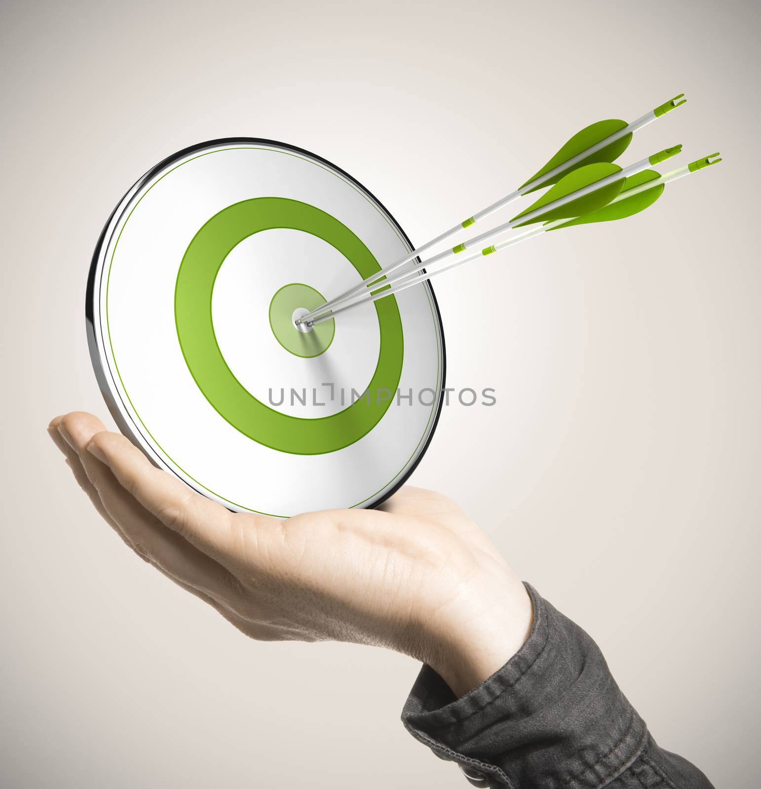 Hand holding a green target with three arrows hitting the center over beige background. Business performance concept.