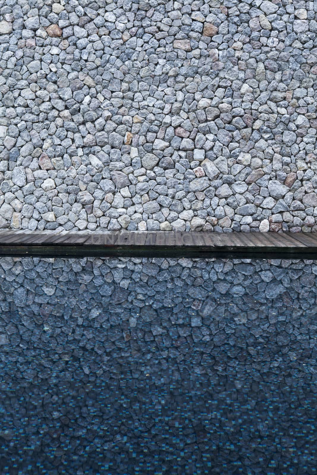 Rock background with reflection in water.