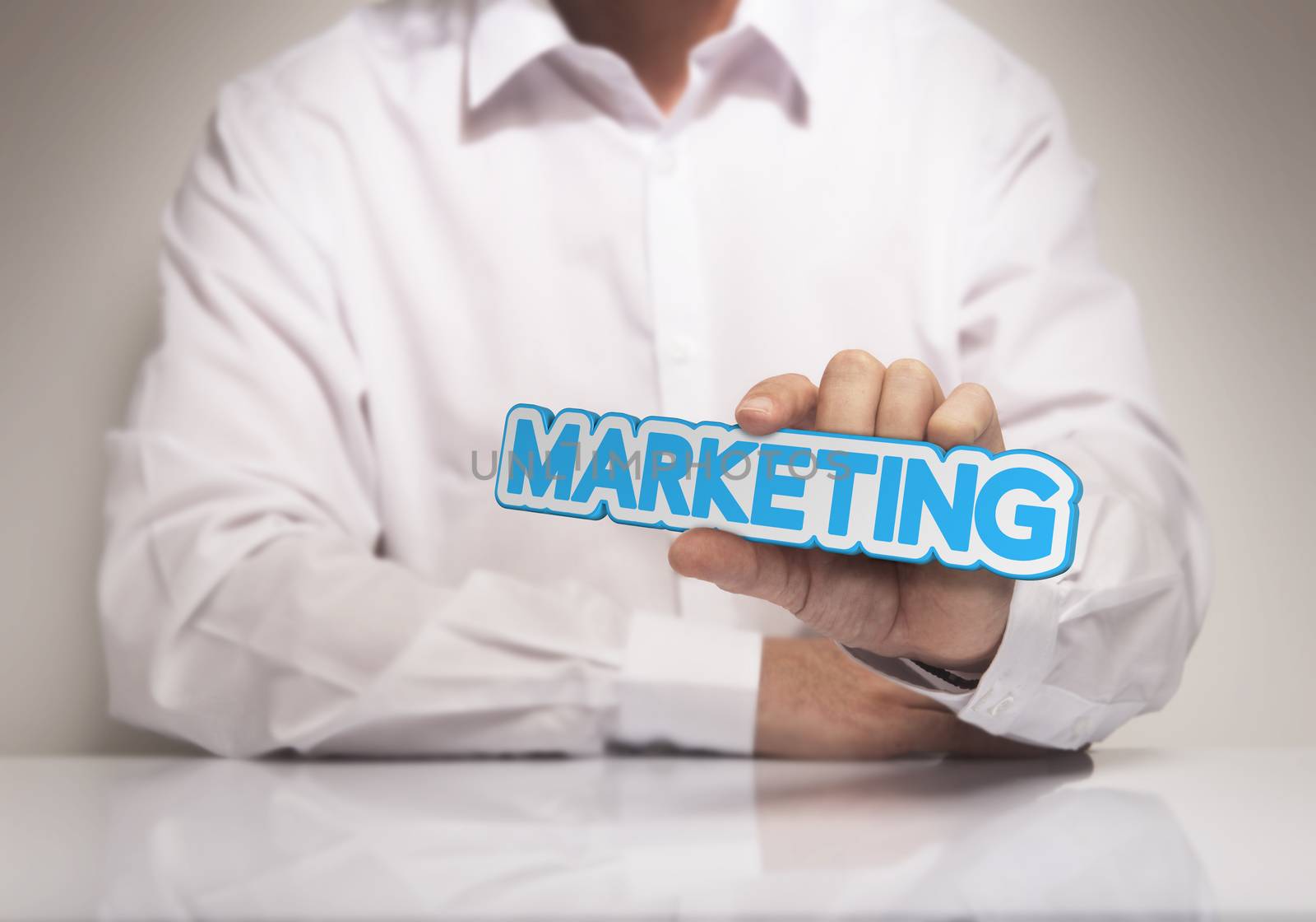 Man hand holding the word Marketing, blue and beige tones, concept image for illustration of marketing solutions