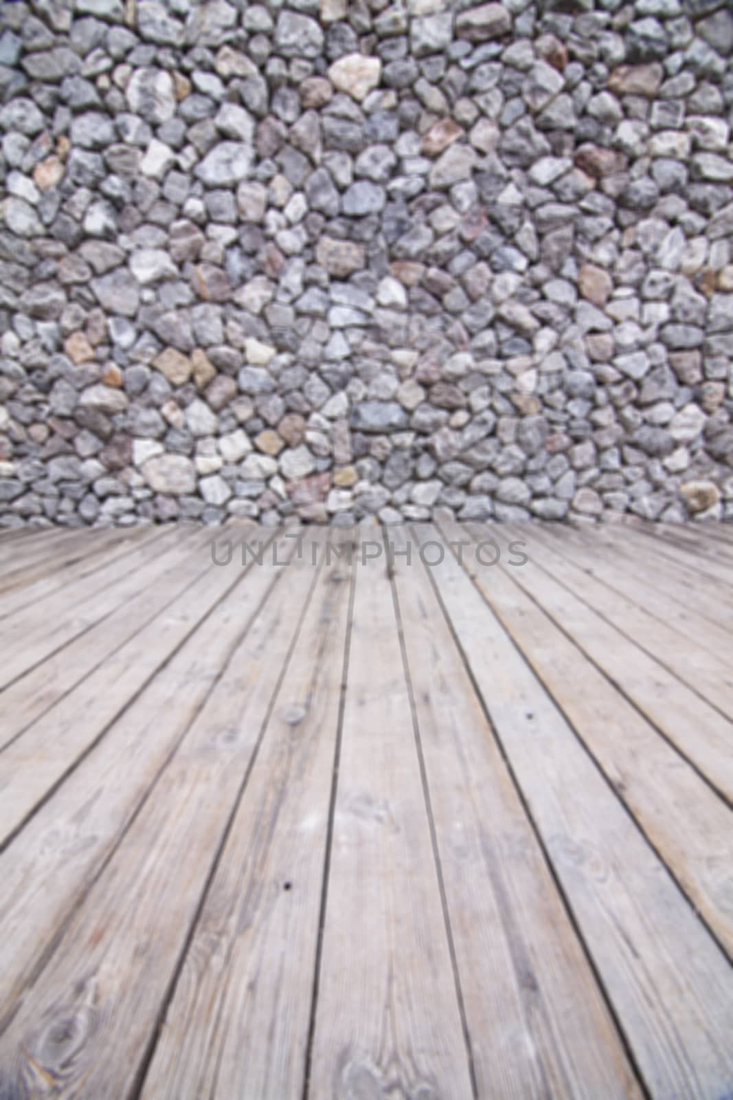 Wooden floor and stone walls background, blur.