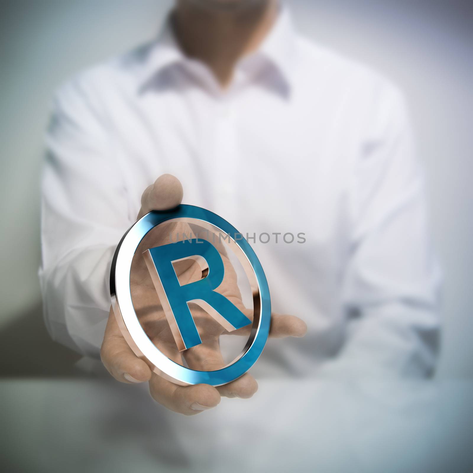 Man holding metallic registered trademark symbol. Concept image for illustration of intellectual property or protection of products or services.