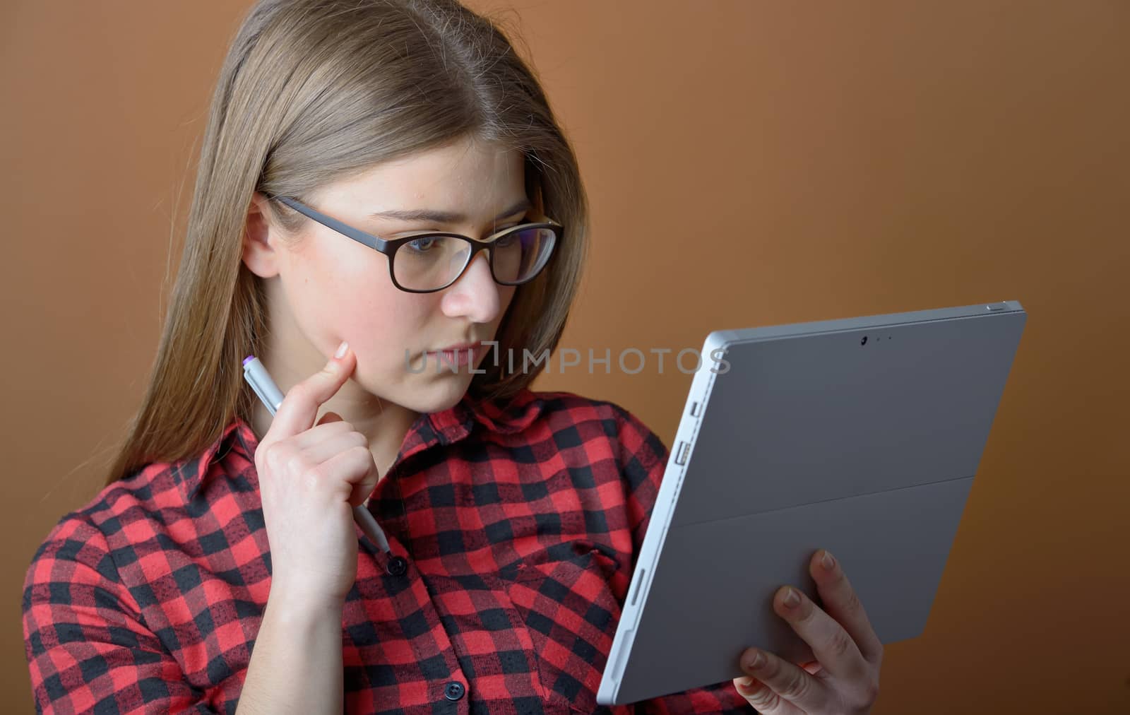 Teenage girl with tablet at home, learning. 
