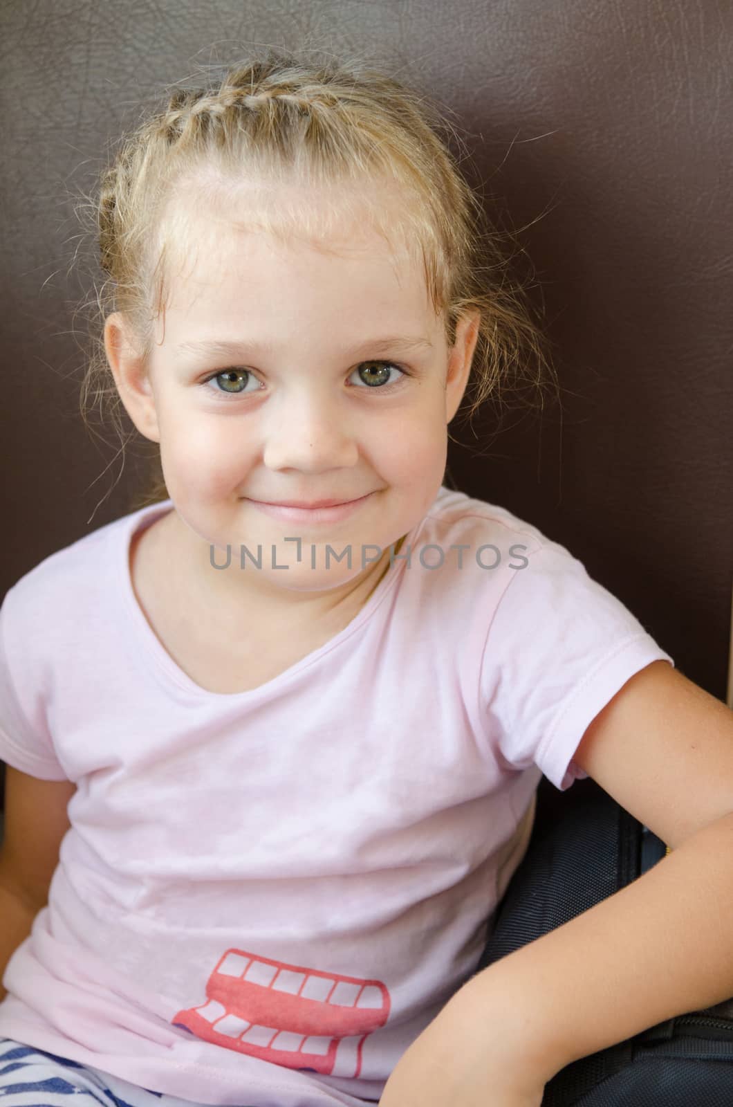 Happy girl sitting on a chair in an electric train