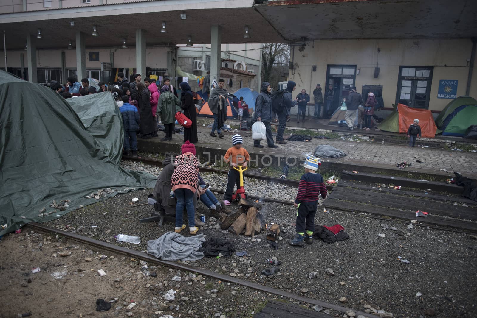 GREECE, Idomeni: Children play along the railway tracks next to tents at the Idomeni refugee camp on the Greek Macedonia border on March 15, 2016 in Idomeni, Greece. Yesterday, an attempt by some of the residents of the camp to cross the border to Macedonia was thwarted by Macedonian security forces who returned the migrants to Greece. The decision by Macedonia to close its border to migrants last week has left thousands of people stranded at the Greek transit camp. The closure, following the lead taken by neighbouring countries, has effectively sealed the so-called western Balkan route, the main migration route which has been used by hundreds of thousands of migrants to reach countries in western Europe, such as Germany. Humanitarian workers have described the conditions at the camp as desperate, which has been made much worse by recent spells of heavy rain.
