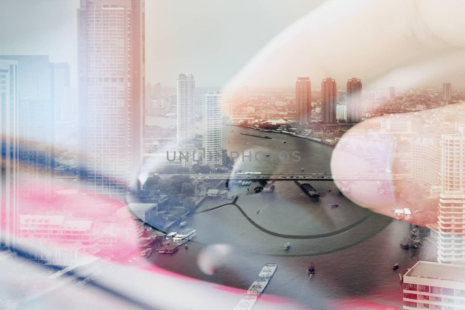 Double exposure image of woman hand on computer mouse and cityscape background,communication technology concept.