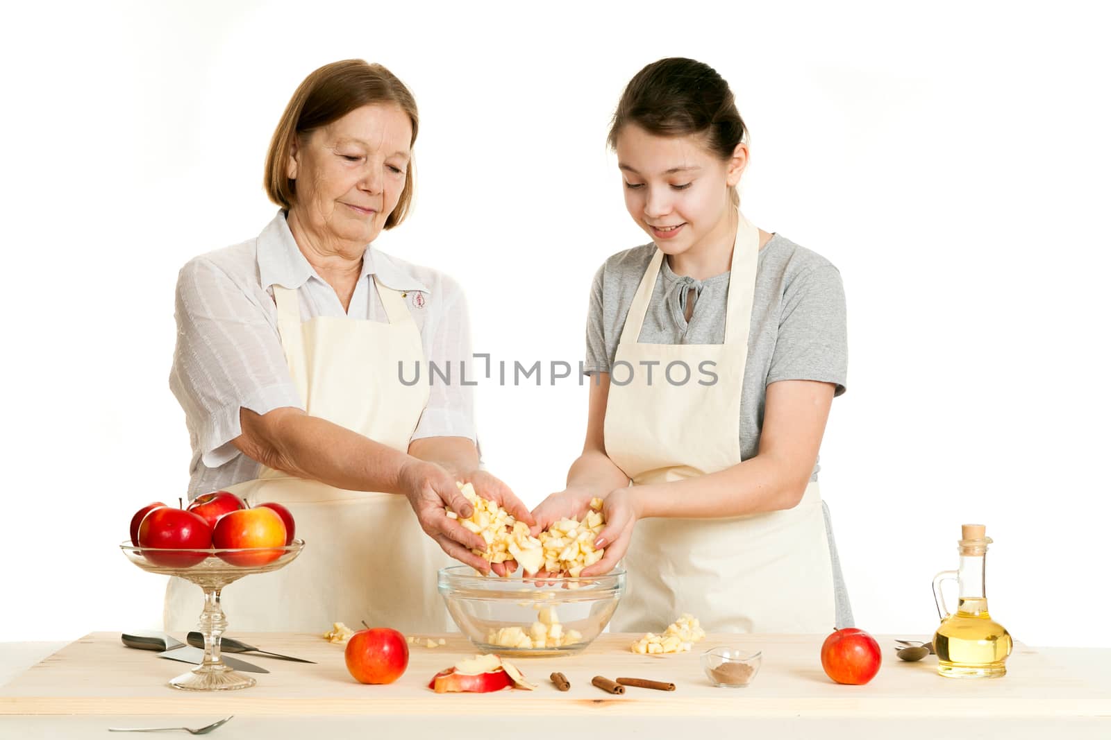 the grandmother and the granddaughter fill ingredients in a bowl by sveter