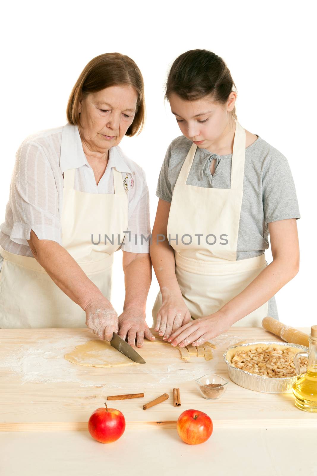 the grandmother and the granddaughter knife dough on a wooden board