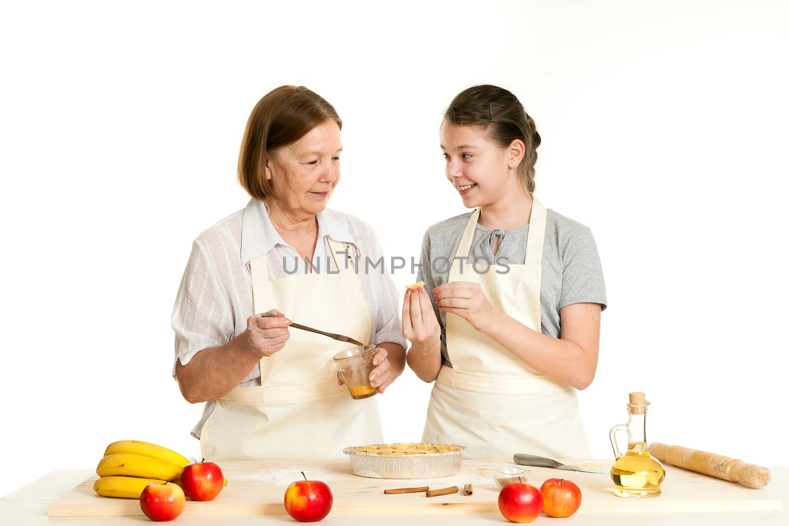 the grandmother and the granddaughter grease pie with a brush with egg