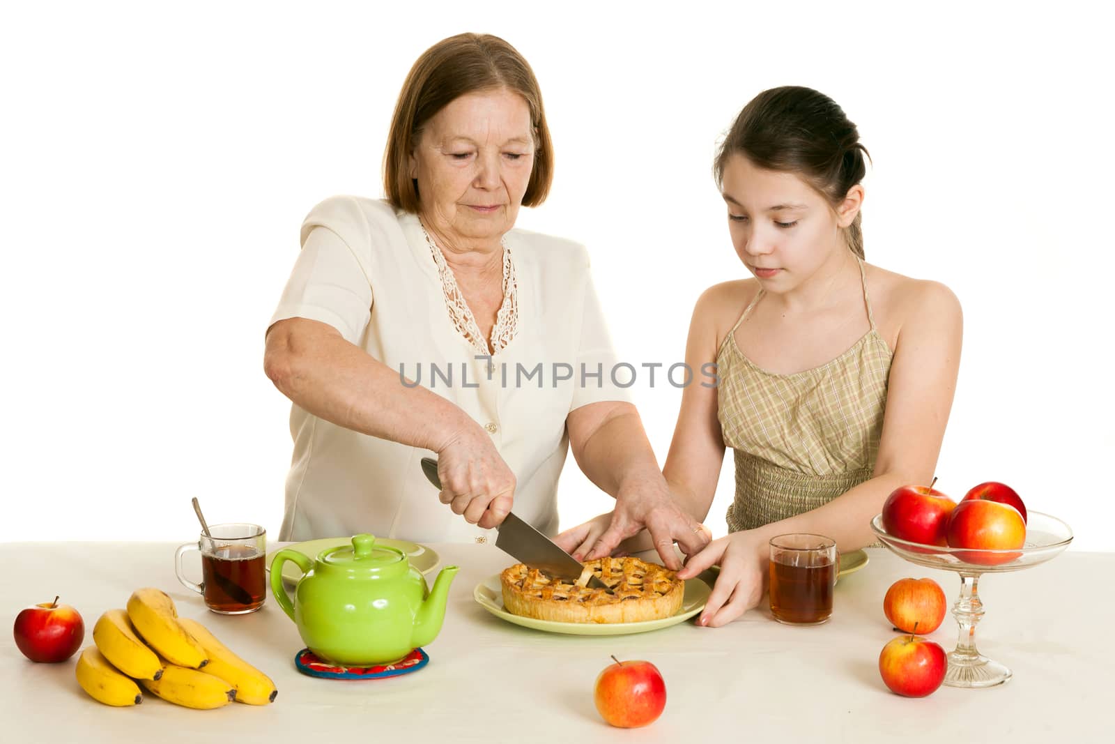 the grandmother treats the granddaughter with pie at a table