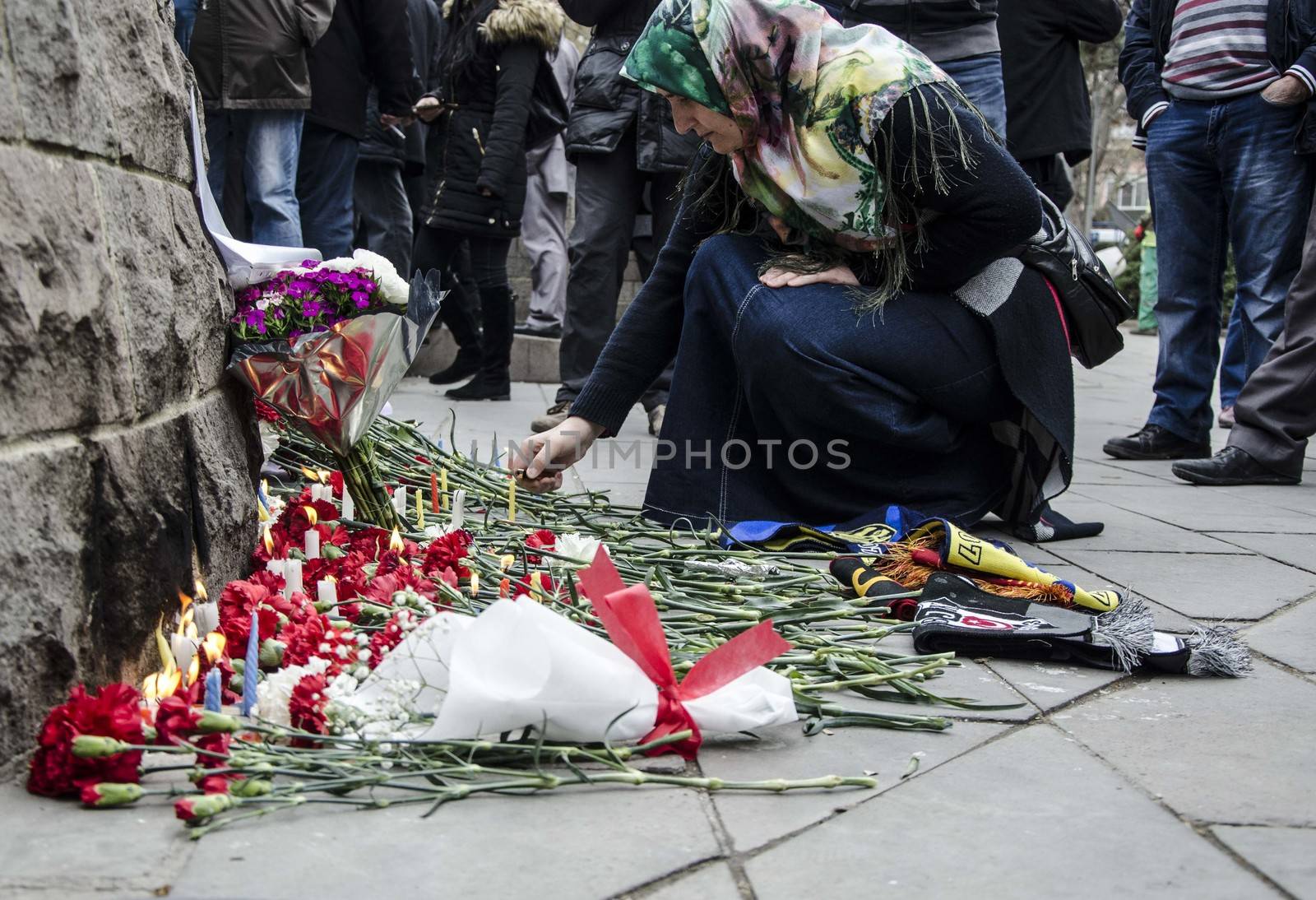 TURKEY, Ankara: A woman leaves carnations at a makeshift memorial for the victims of Sunday's suicide bomb attack in Ankara, on March 15, 2016 in Ankara, near the site of a suicide car bombing on March 13 that left 35 dead.Turkish warplanes pounded Kurdish rebel bases in northern Iraq on March 14, the day after a suicide car bomb tore through downtown Ankara killing at least 35 people, the third attack on the capital in five months. There was no immediate claim of responsibility for the latest carnage, which reduced cars and buses to charred hulks on a busy road in the heart of the city, wounding more than 120 people. 