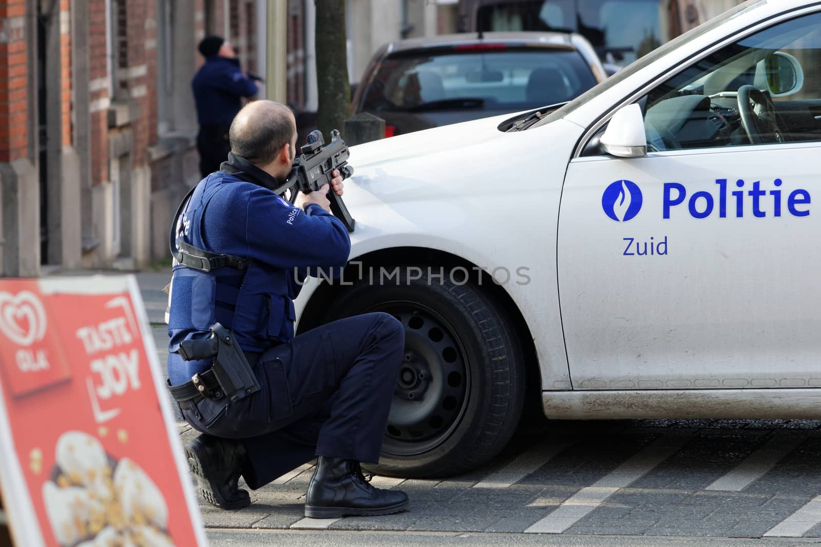 BELGIUM, Brussels: A police officer takes aim at the site of a shooting on Dries-Driesstraat at Forest-Vorst, in Brussels, on March 15, 2016. Shots were fired at Belgian police in the capital Brussels as they carried out an operation linked to the Paris attacks, Belgian prosecutors told.