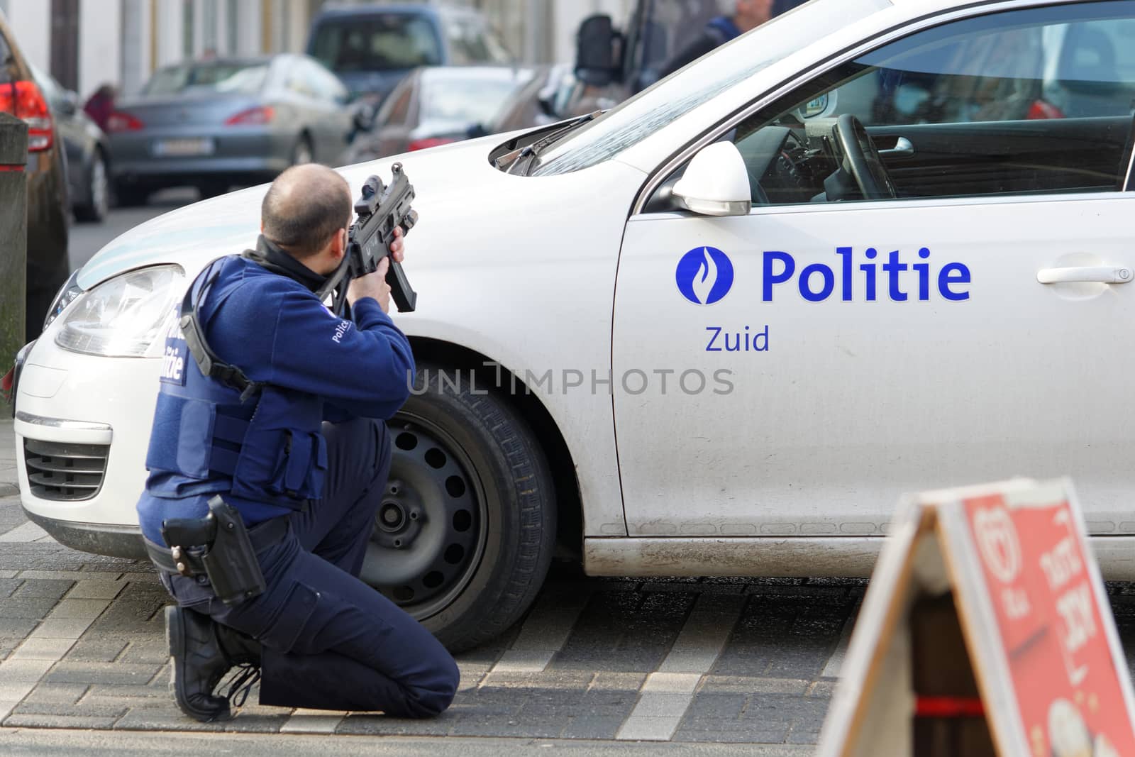 BELGIUM, Brussels: A police officer takes aim at the site of a shooting on Dries-Driesstraat at Forest-Vorst, in Brussels, on March 15, 2016. Shots were fired at Belgian police in the capital Brussels as they carried out an operation linked to the Paris attacks, Belgian prosecutors told.