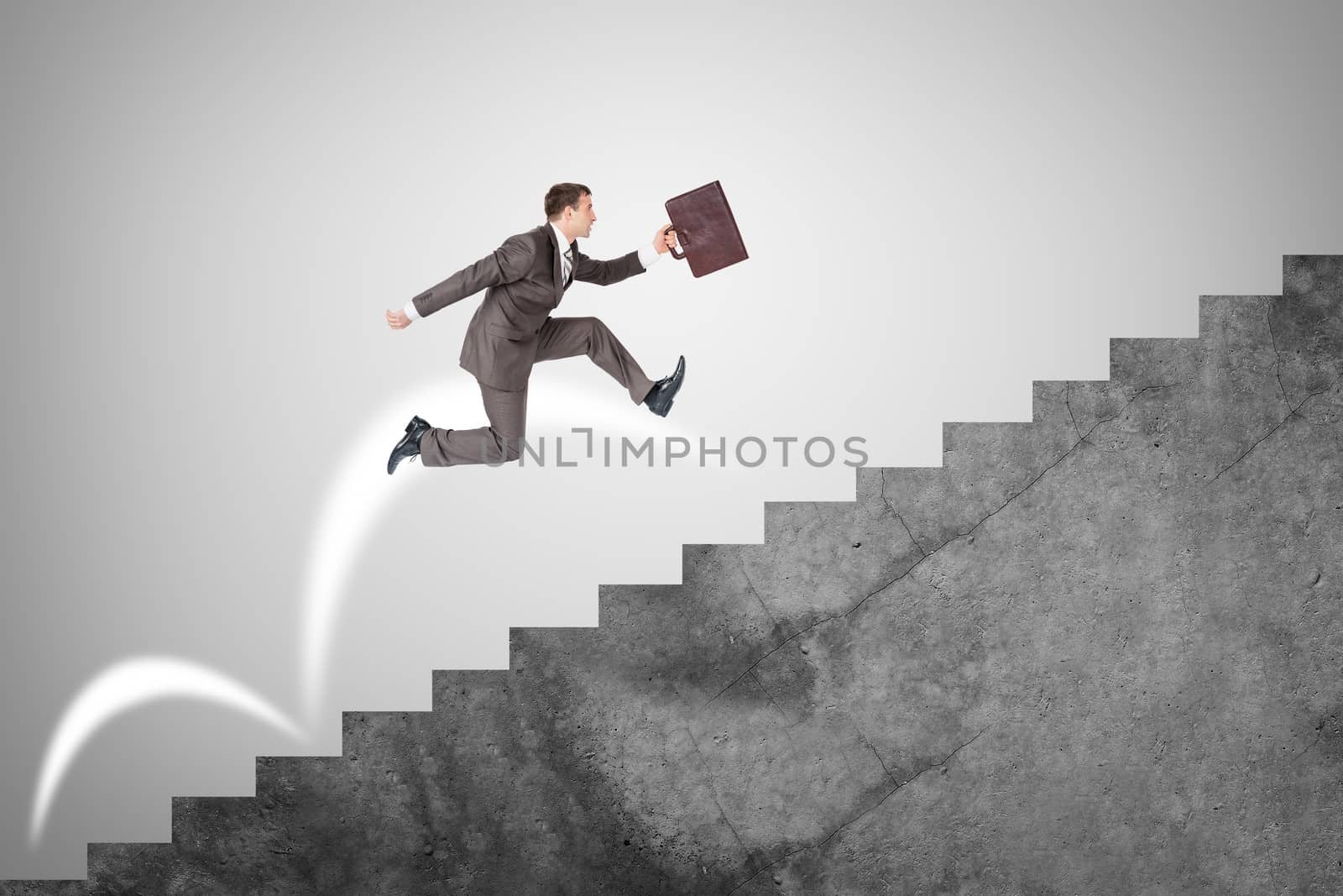 Businessman with suitcase running fast up stairs