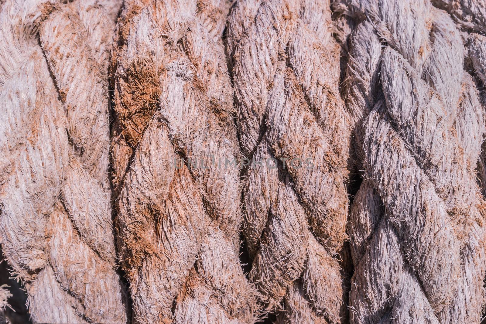 Close-up of an old frayed boat rope as a nautical background.