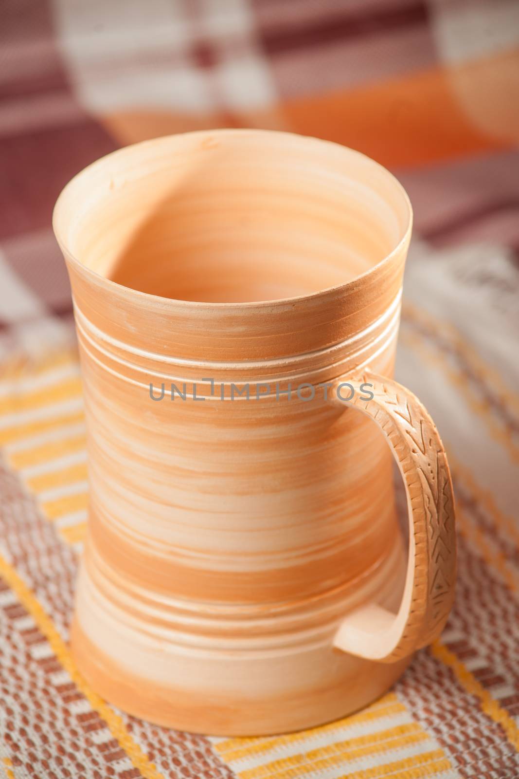 Traditional handcrafted mug on multycolor background. High resolution