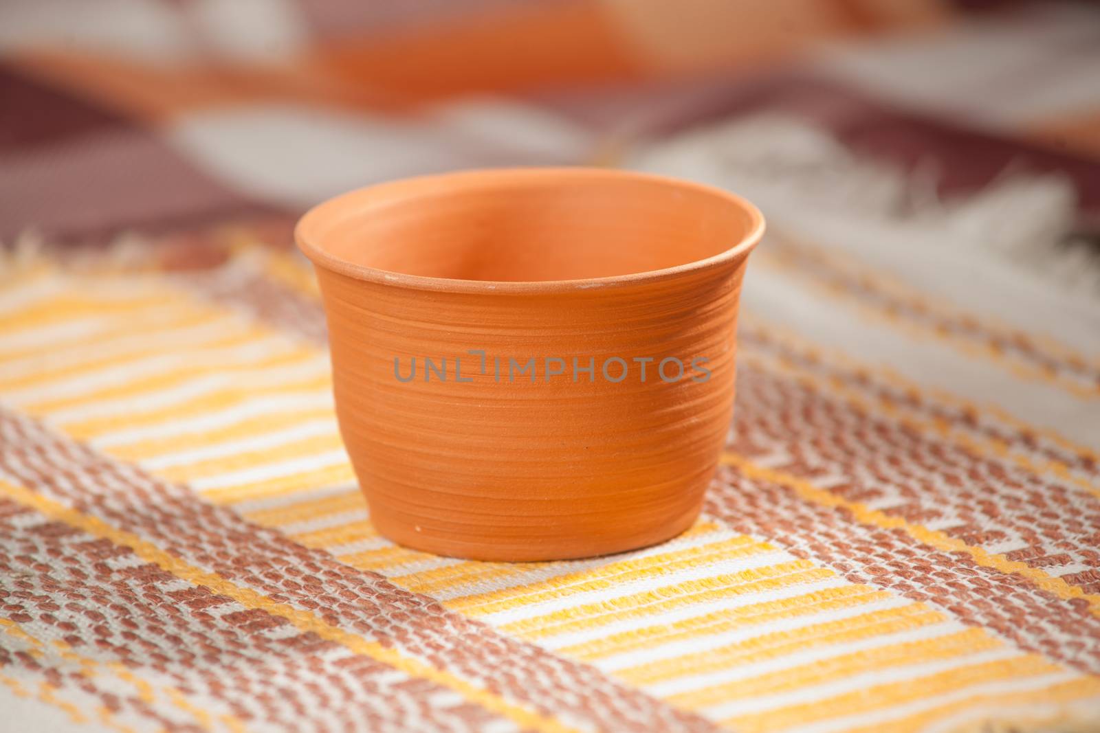 Traditional handcrafted mug on multycolor background. High resolution