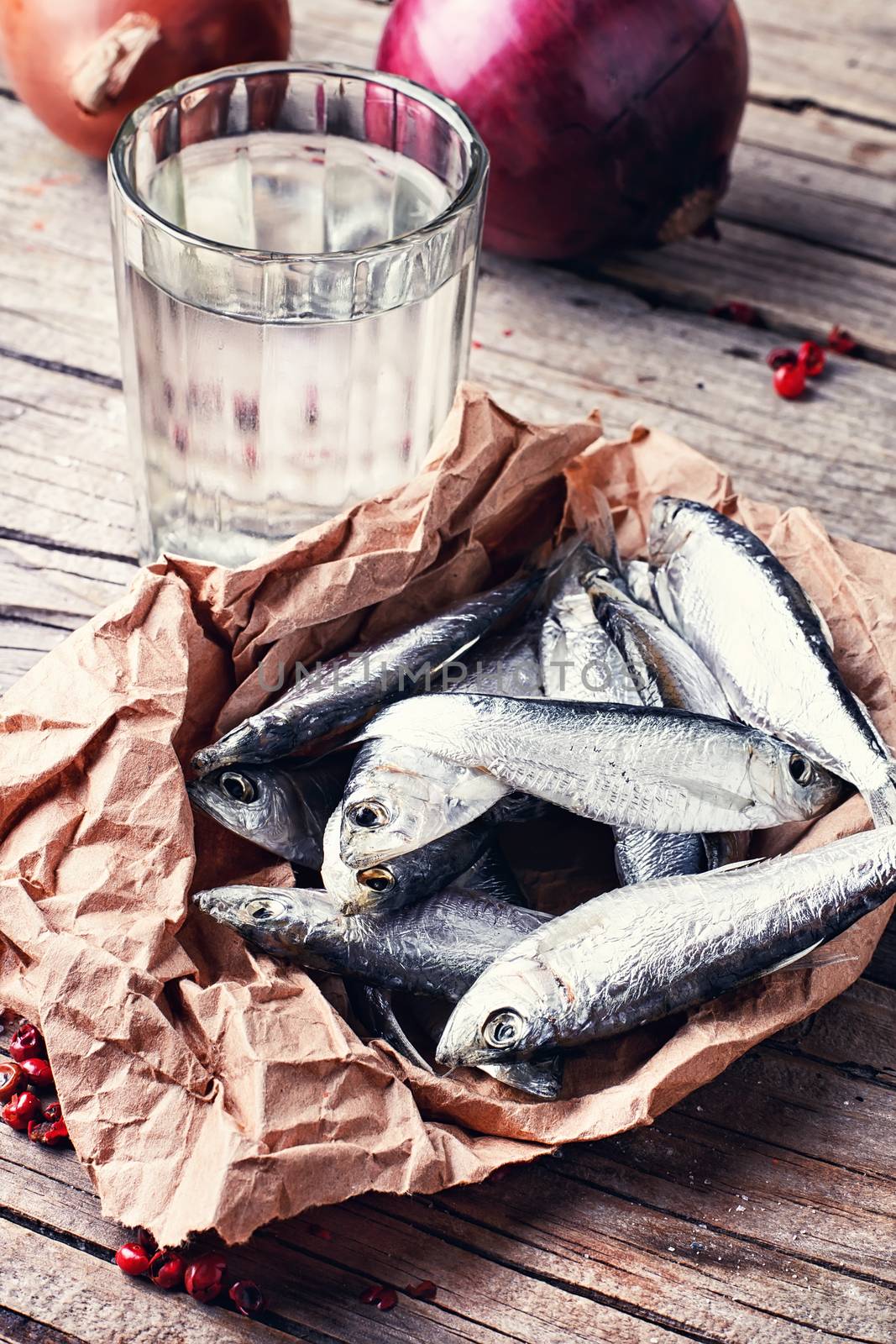 Glass of vodka,smoked sprat,spices in a rustic traditional Russian style