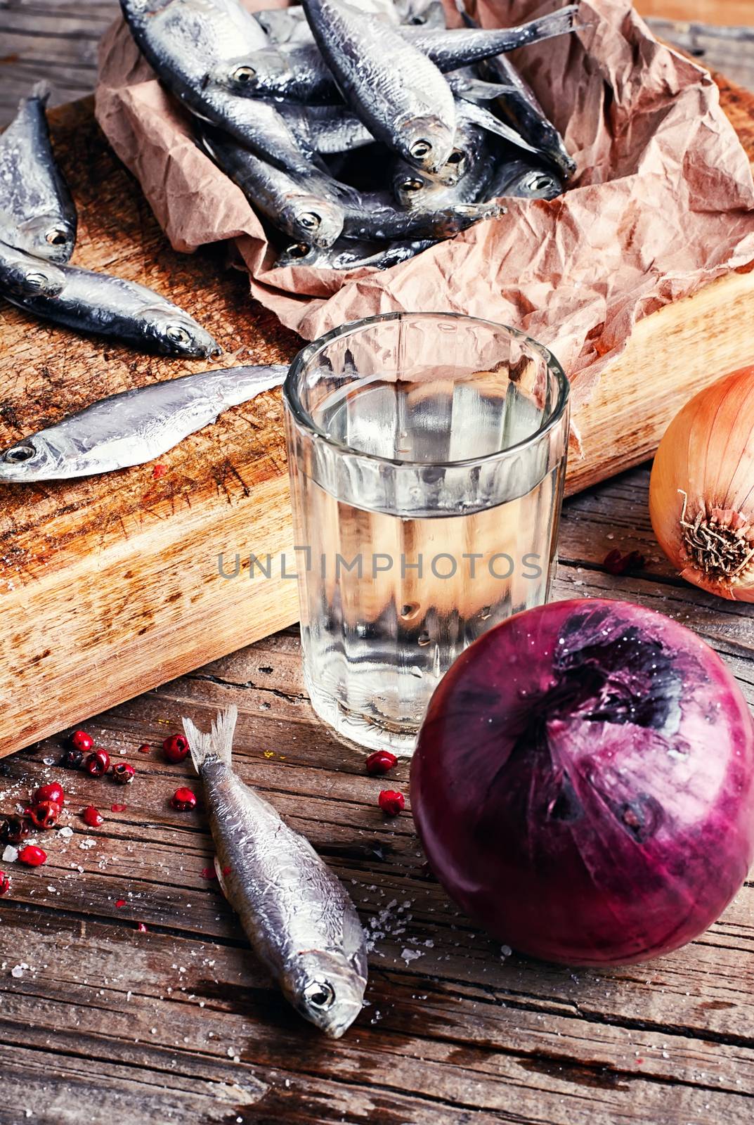 Glass of vodka,smoked sprat,spices in a rustic traditional russian style