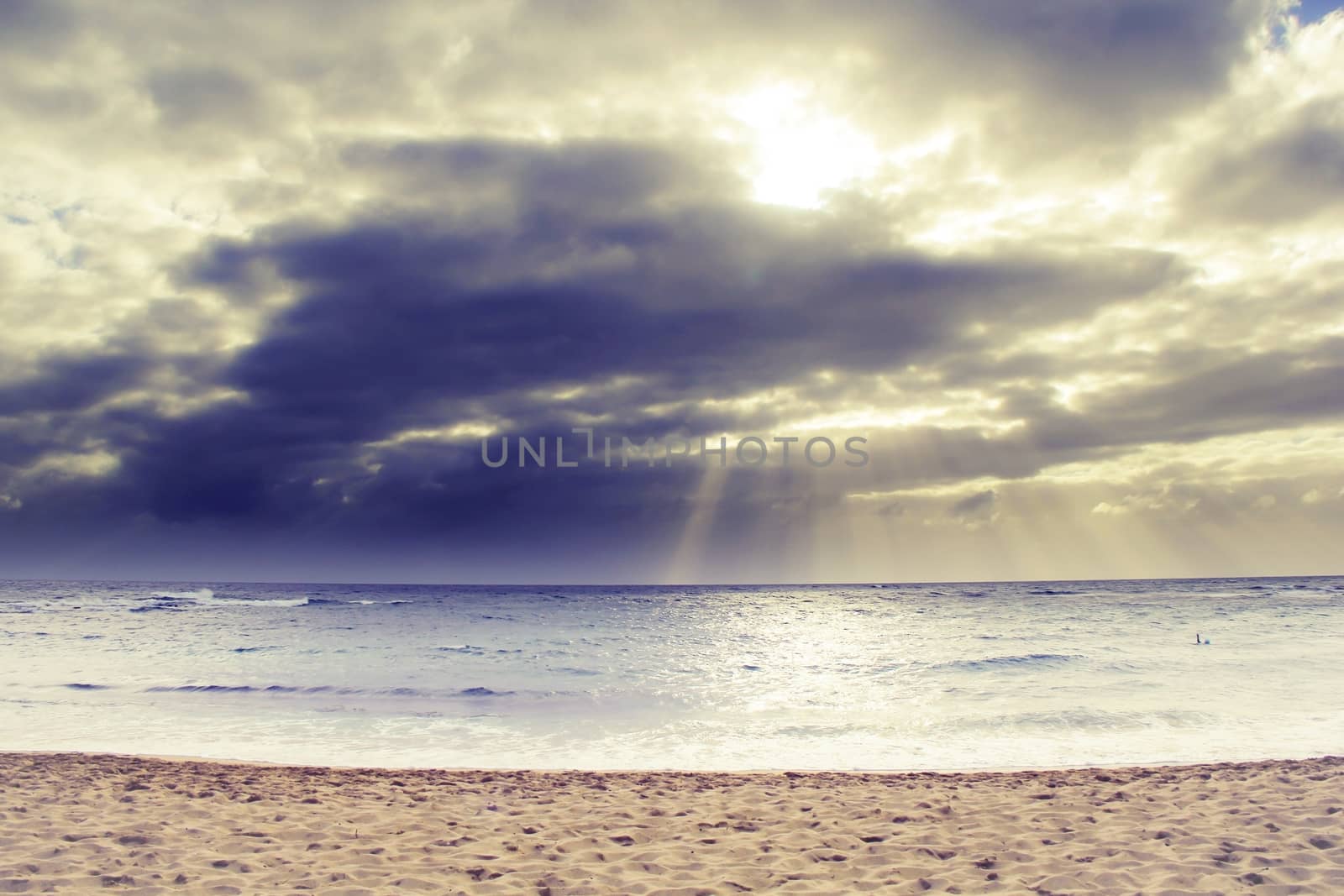 ray of sun over the beach at Kauai, Hawaii with cloudy sky by Timmi