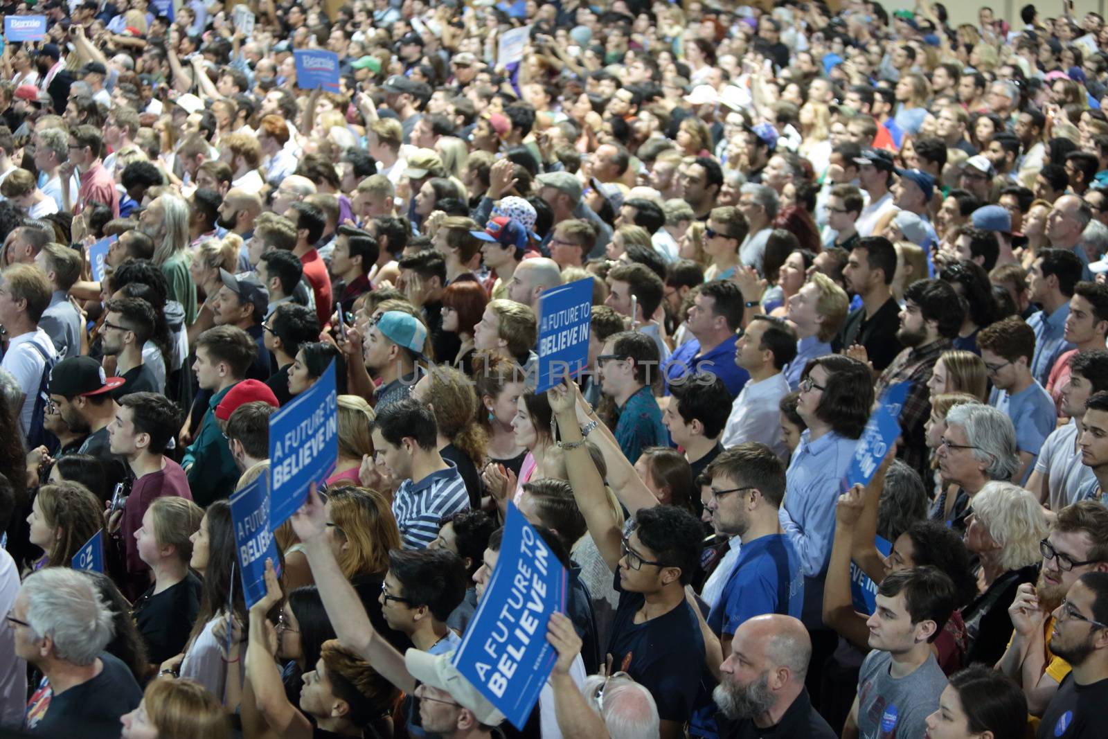 UNITED STATES, Phoenix: Members of the crowd show their support for Democratic presidential candidate Sen. Bernie Sanders at the Phoenix Convention Center during a campaign rally on March 15, 2016 in Phoenix, Arizona. Hillary Clinton won the Democratic primary elections in Florida, North Carolina and Ohio, while Missouri and Illinois remain tight races.